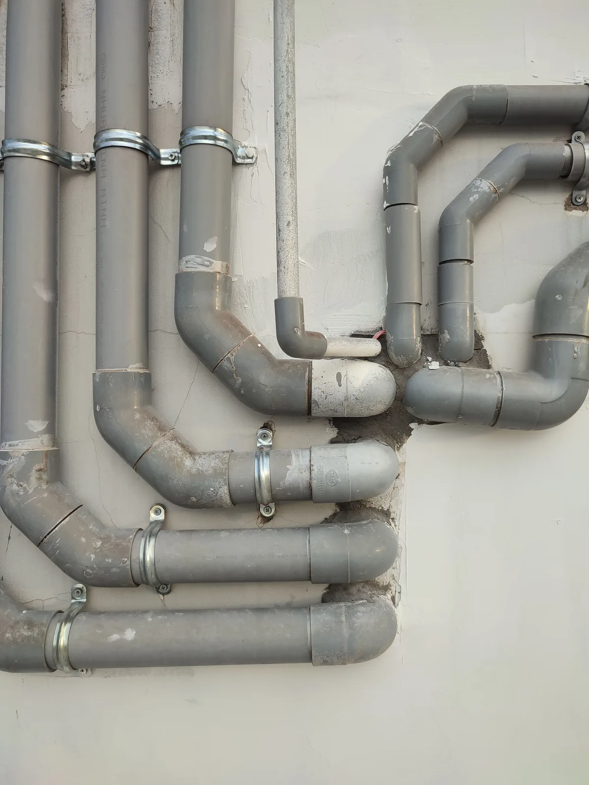 PVC plumbing pipes and fittings, representative of pool equipment-pad and underground plumbing connections where leaks commonly occur