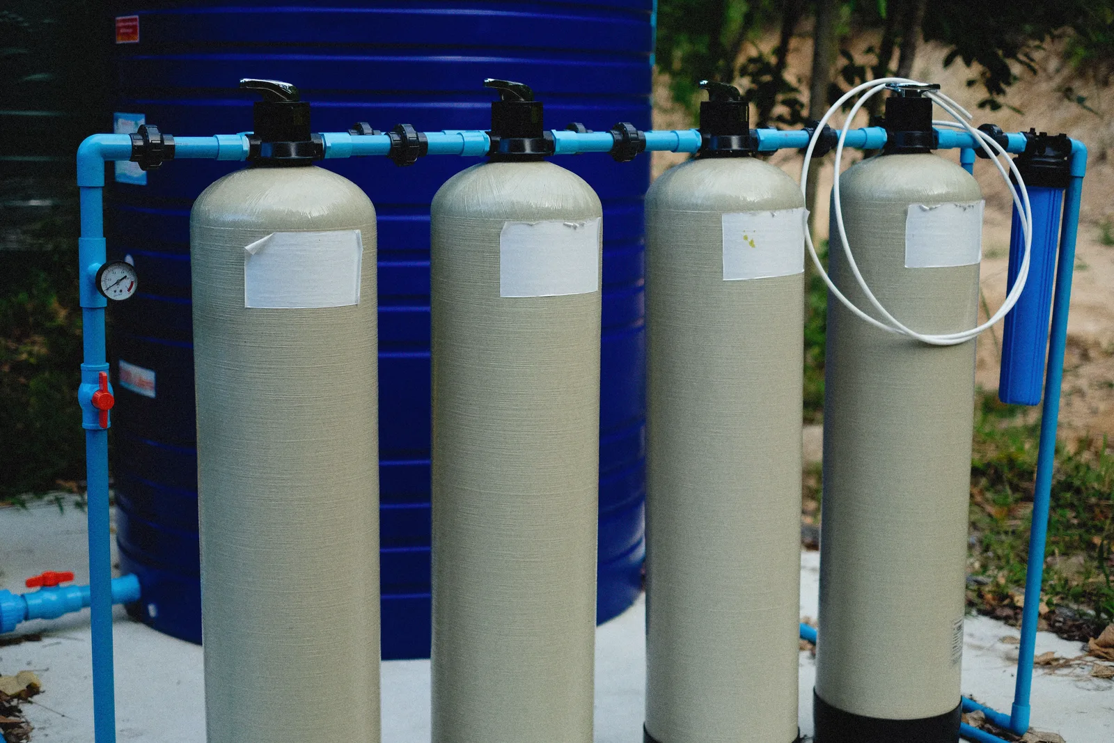 Residential pool filter tanks and above-ground plumbing and piping at a pool equipment pad